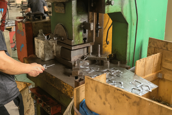 Worker operating metal stamping press